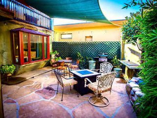 Cozy outdoor patio setup with a seating area, tiled floor, and an array of potted plants